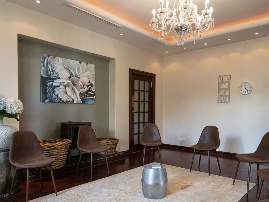 Rehab centre group therapy room, with chairs set up in a square and a luxurious, light interior.