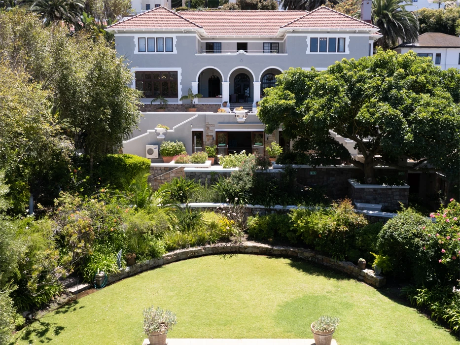 Rehab centre Connection MHC in South Africa, surrrounded by a lawn and garden with trees.