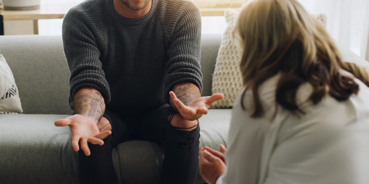 A man speaks openly during a therapy session, showing how discussing trauma and difficult experiences can be part of the healing and recovery process.