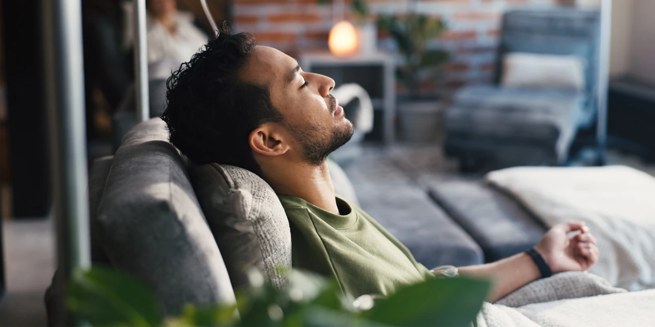 man-resting-on-sofa-during-recovery