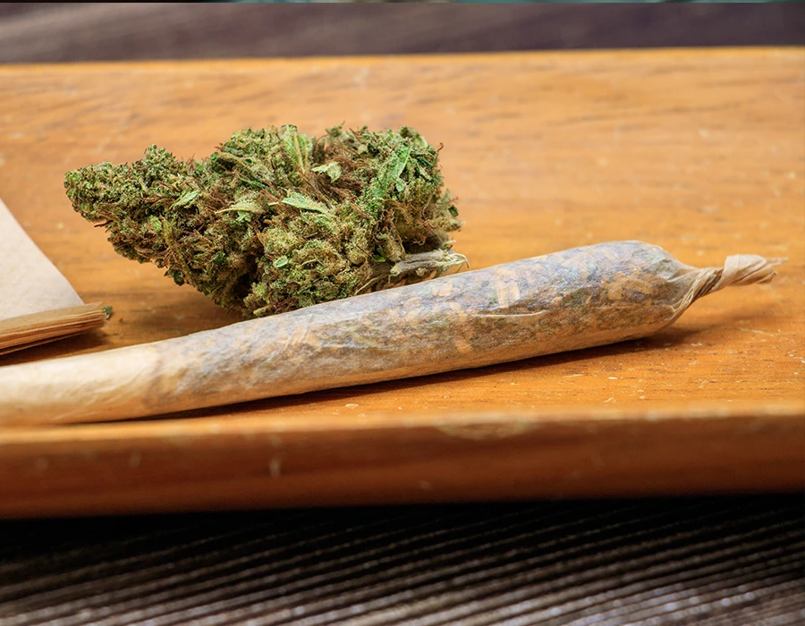 Cannabis bud and joint illustrating weed addiction and treatment.