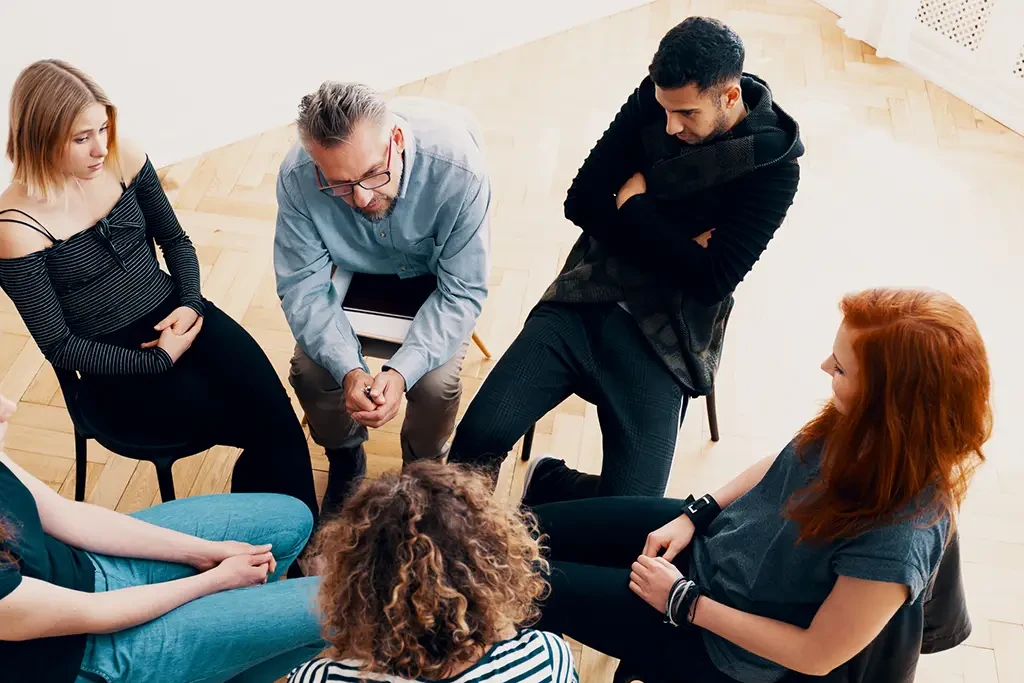 A group of people in a conversational circle.