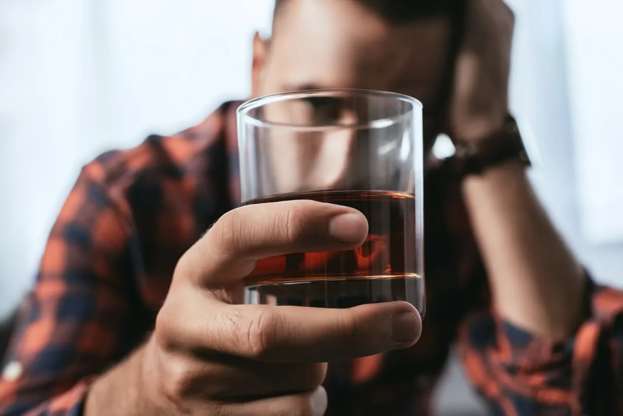 man-holding-whiskey-glass