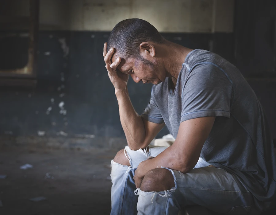 Man experiencing stress and discomfort during weed withdrawal.