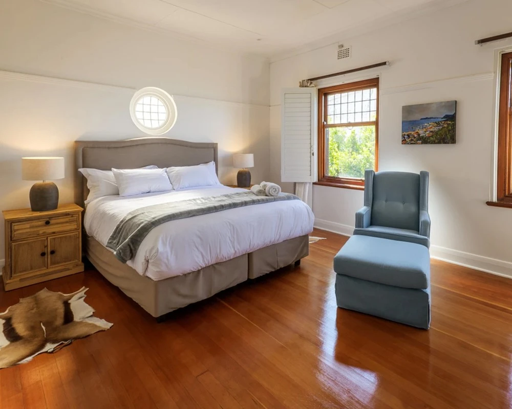 Spacious bedroom with a double bed in a rehabilitation clinic in South Africa.