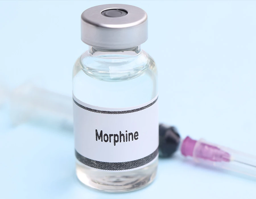 Vial labelled morphine with a syringe on a light blue background, illustrating morphine addiction.