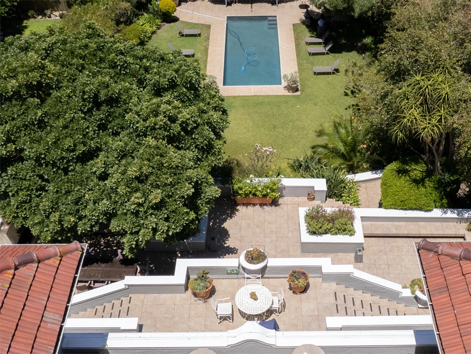 Rehab centre Connection MHC in South Africa, top view, showing the terrace which overlooks the garden with pool and trees.